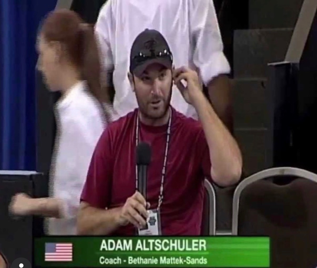 Kuba Ostajewski watching on while coaching a WTA match.